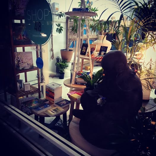 Night window display at Chelsea Bookshop with Buddha statue